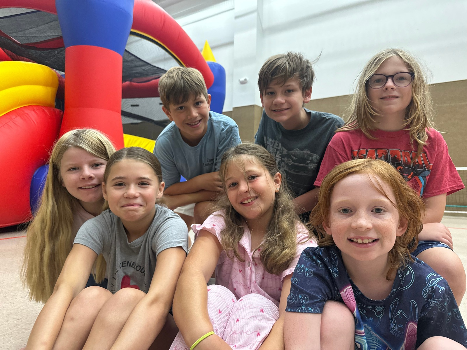 CTR kids gathered by an inflatable bounce house in the gym
