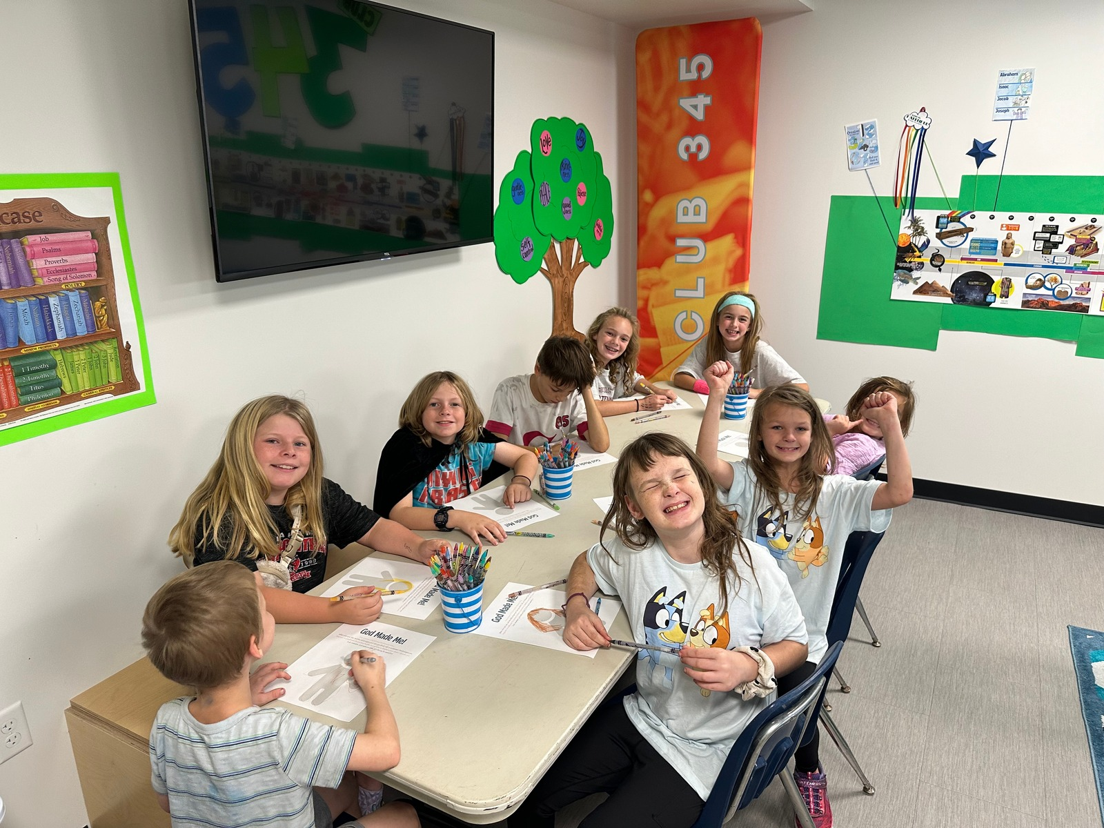 Club 345 kids coloring together in the classroom